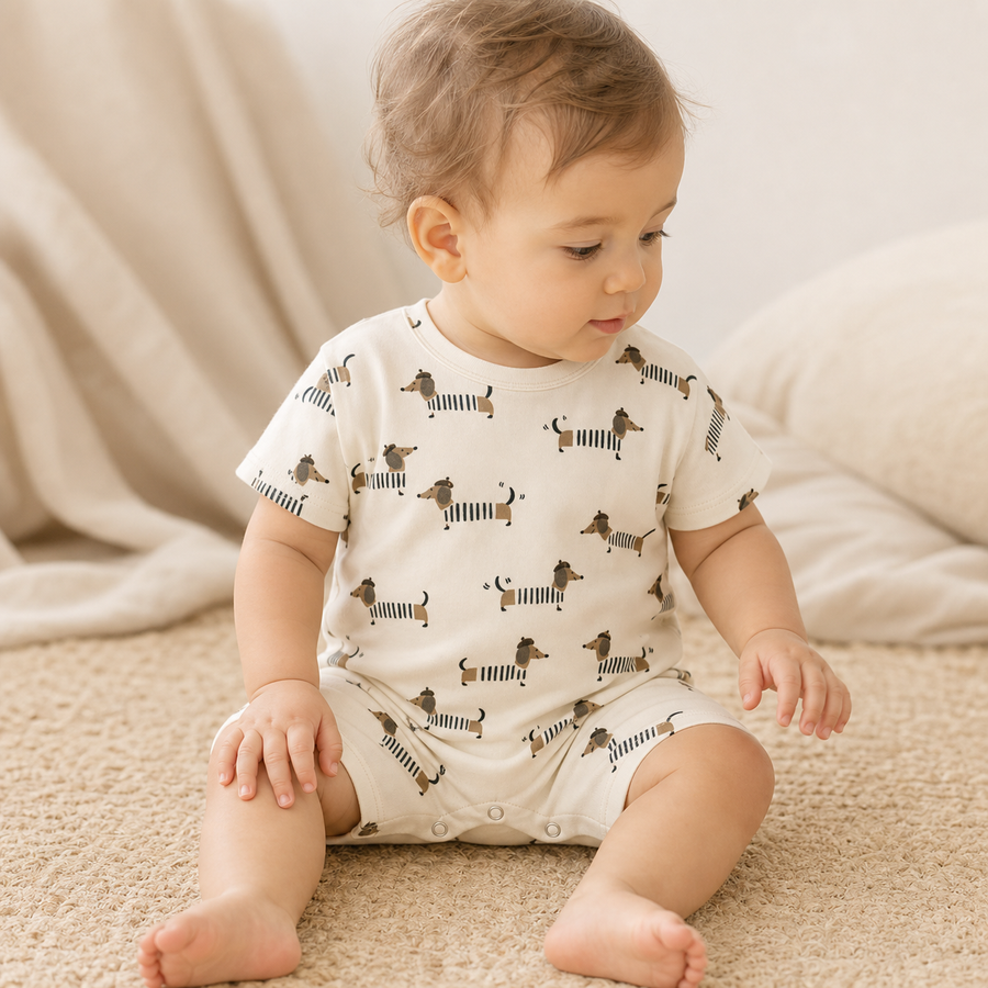 Baby wearing the Printed Cotton Baby Romper in the Dogs print