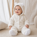 Gentle Nest model hero — Cozy Cub Winter Romper, White, worn by Eli (GN-B02)