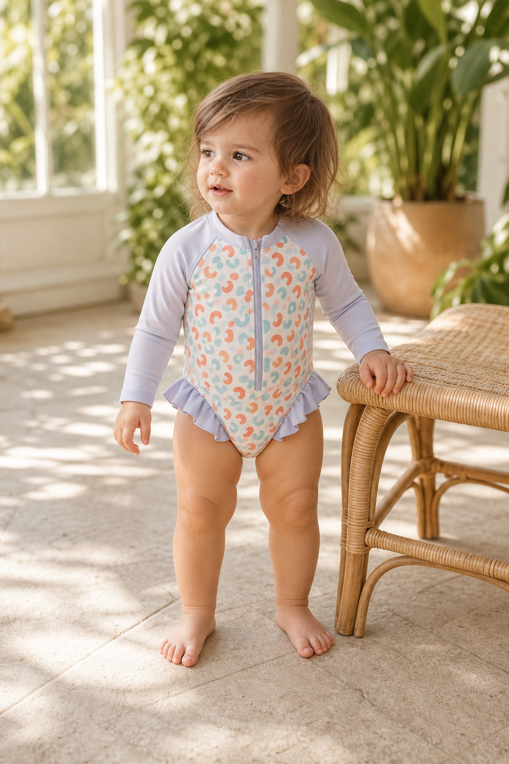 Gentle Nest model hero — Floral Ruffle Romper, worn by Mila (GN-T02)