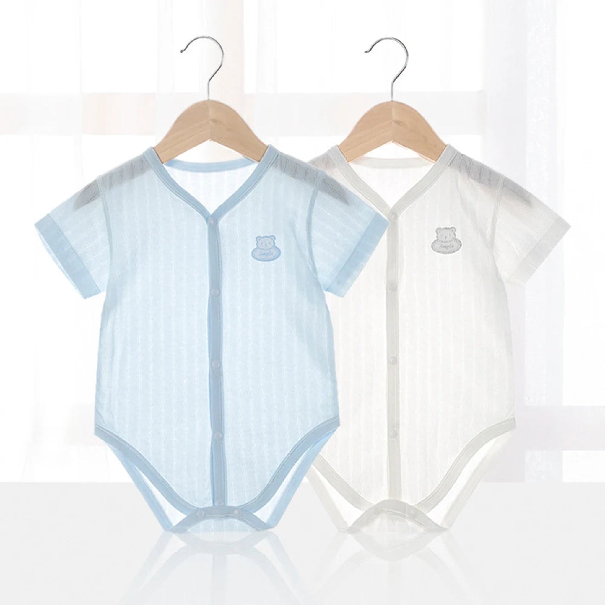 Knit short sleeve bodysuit color assortment on hangers