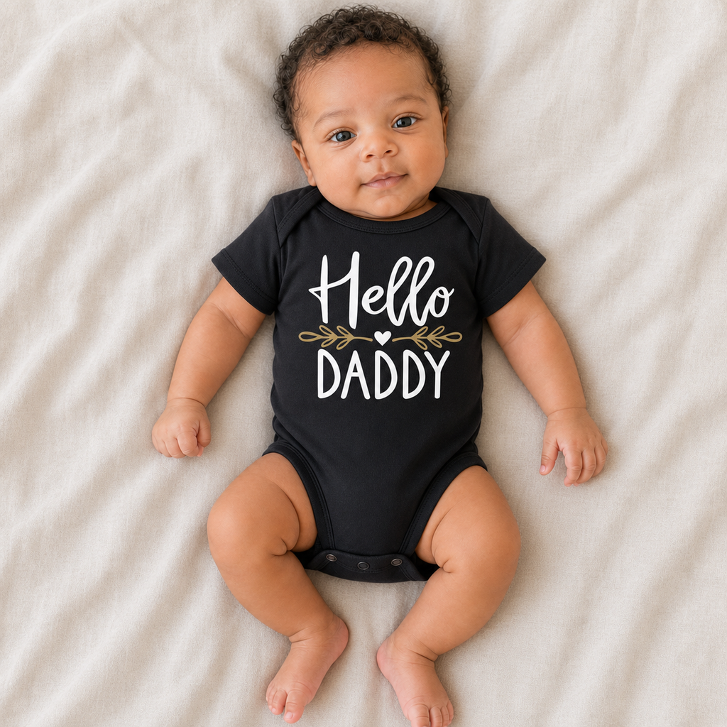Gentle Nest model hero — Hello Daddy Baby Announcement Romper, Black, worn by Amari (GN-N01)