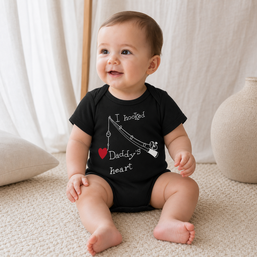 Gentle Nest model hero — Daddy's Heart Printed Romper, Black, worn by Eli (GN-B02)