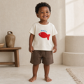 Gentle Nest model hero — Little Fish Patch Tee, Beige, worn by Malik (GN-T06)