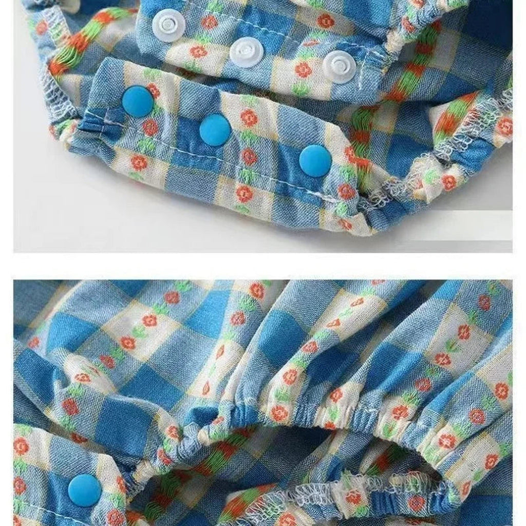 Snap detail on blue checkered romper