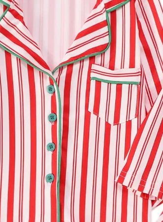 Striped Christmas pajama top, close-up of green piping, buttons and chest pocket