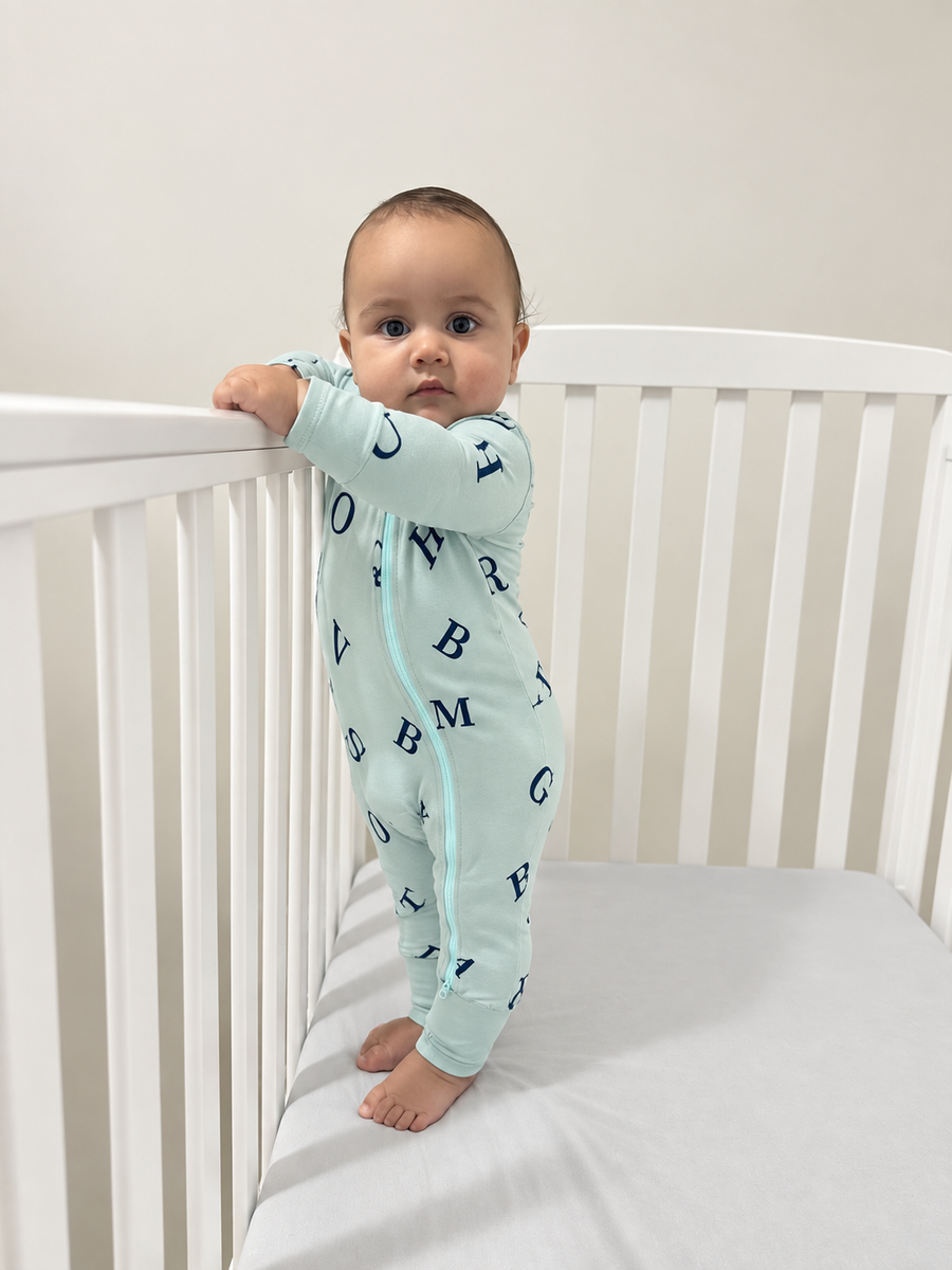 Jordan modeling the Alphabet Romper by GentleNest Co.