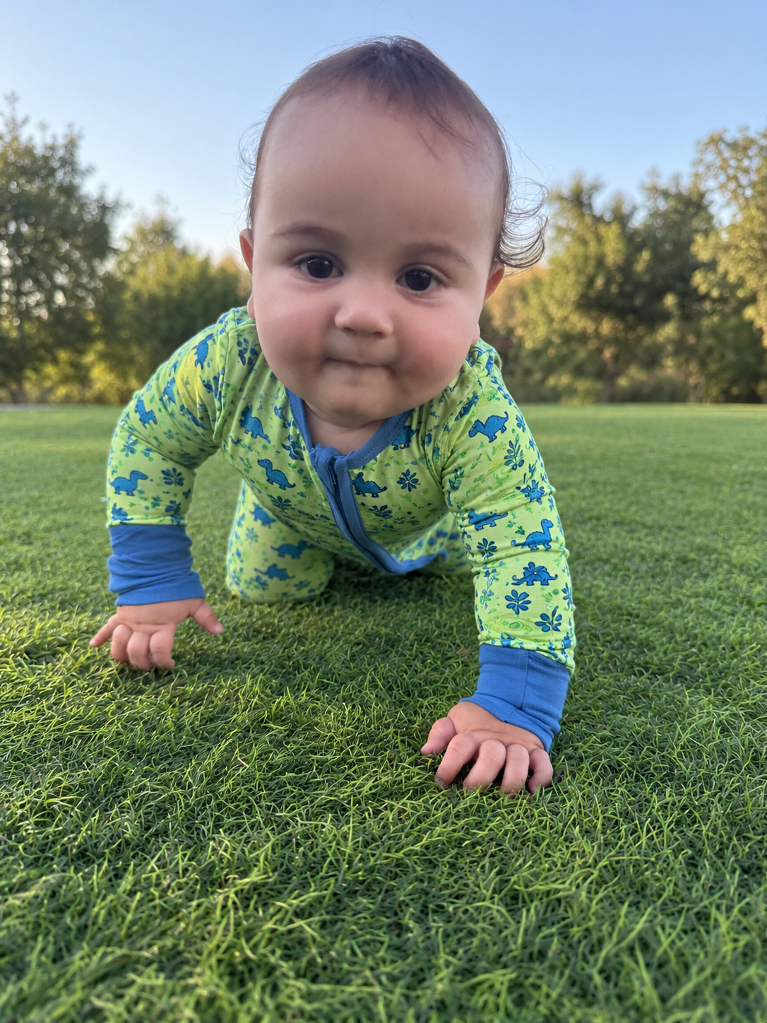 Jordan modeling the Dino Meadow Romper by GentleNest Co.