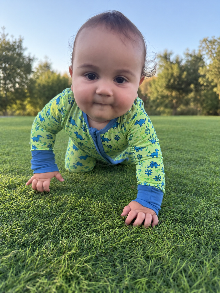 Jordan modeling the Dino Meadow Romper by GentleNest Co.