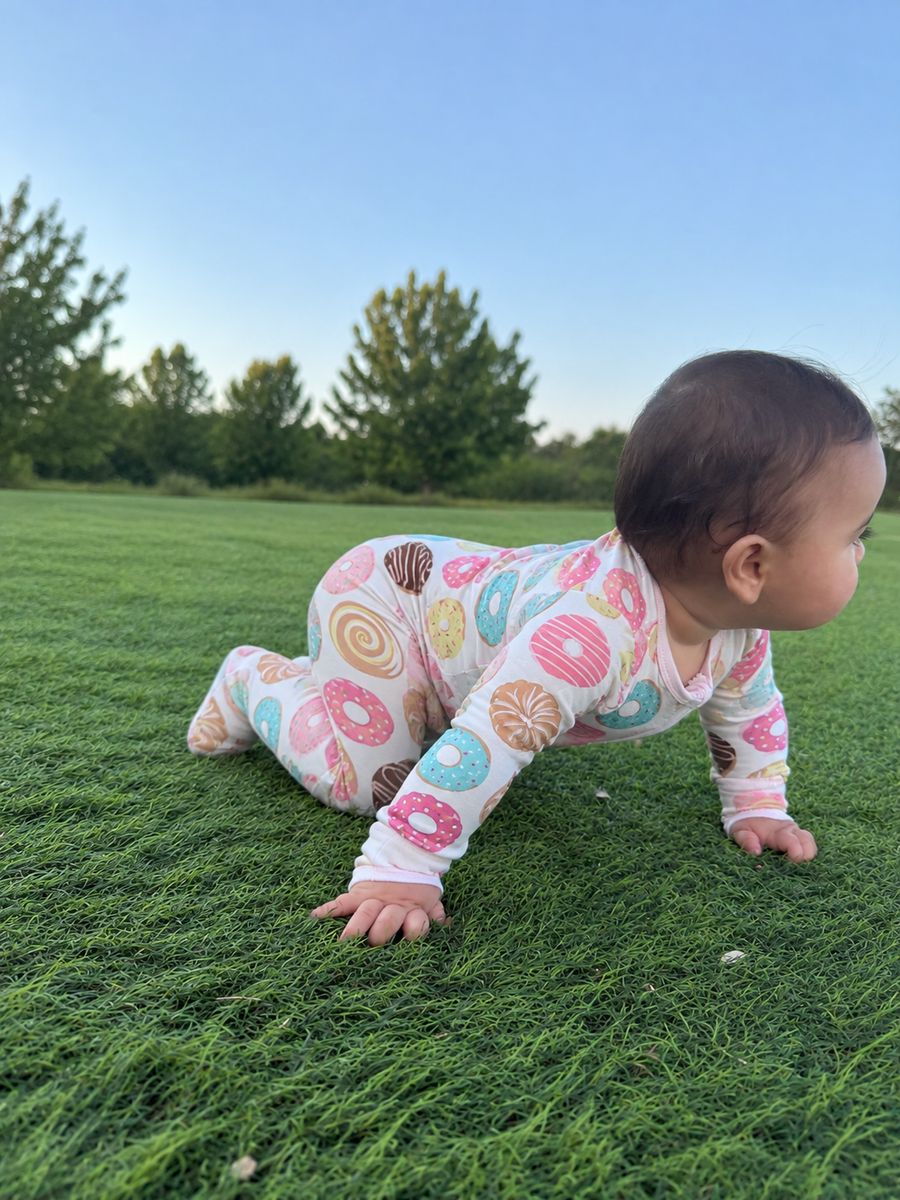 Jordan modeling the Doughnut Footed Romper by GentleNest Co.