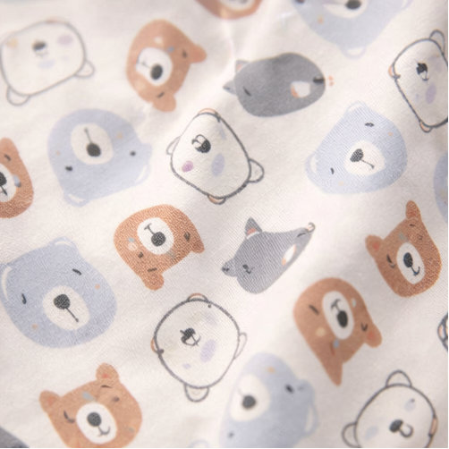 Collection of baby clothing items including a onesie with a bear face and 'bear sweet' text, striped shirt, and patterned fabric with animal designs.