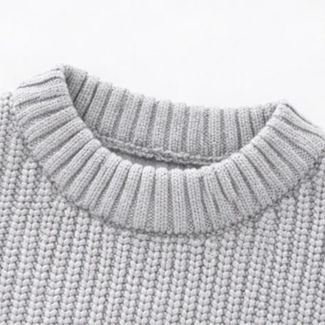 Close-up of a gray knit sweater on a white background