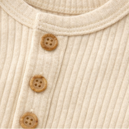 Collage of a beige ribbed baby onesie with buttons on a light background