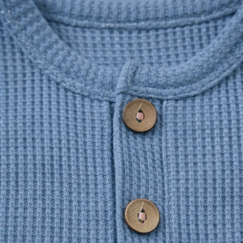 Collage of a blue textured garment with buttons and a pocket.