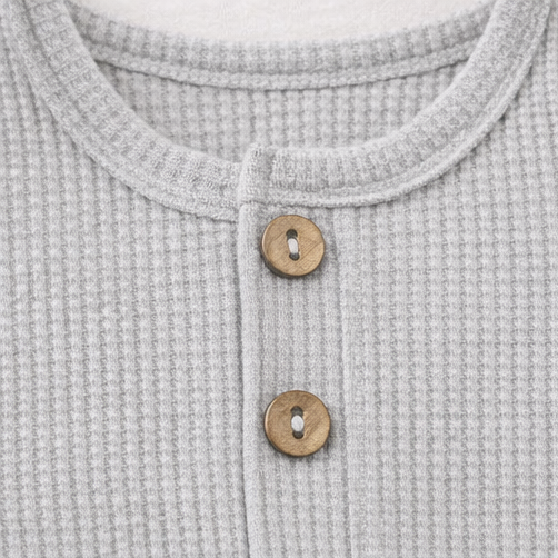 Collage of close-up details of a gray textured garment with buttons and a pocket.
