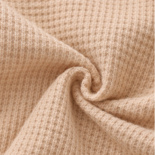 Collage of a beige baby romper with close-up details on a white background