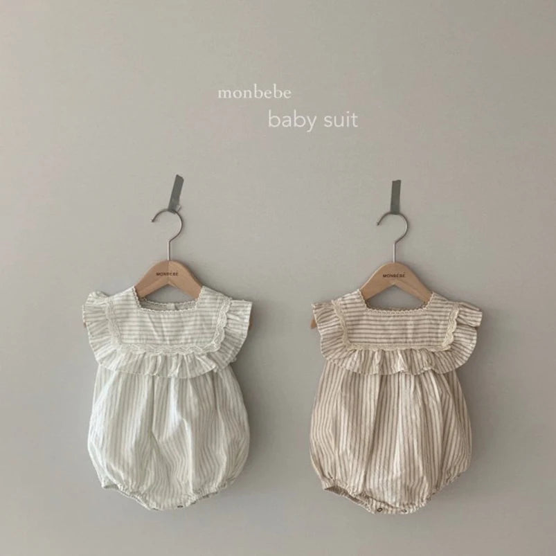 Close-up of vintage stripe romper dress with ruffles and lace for girls