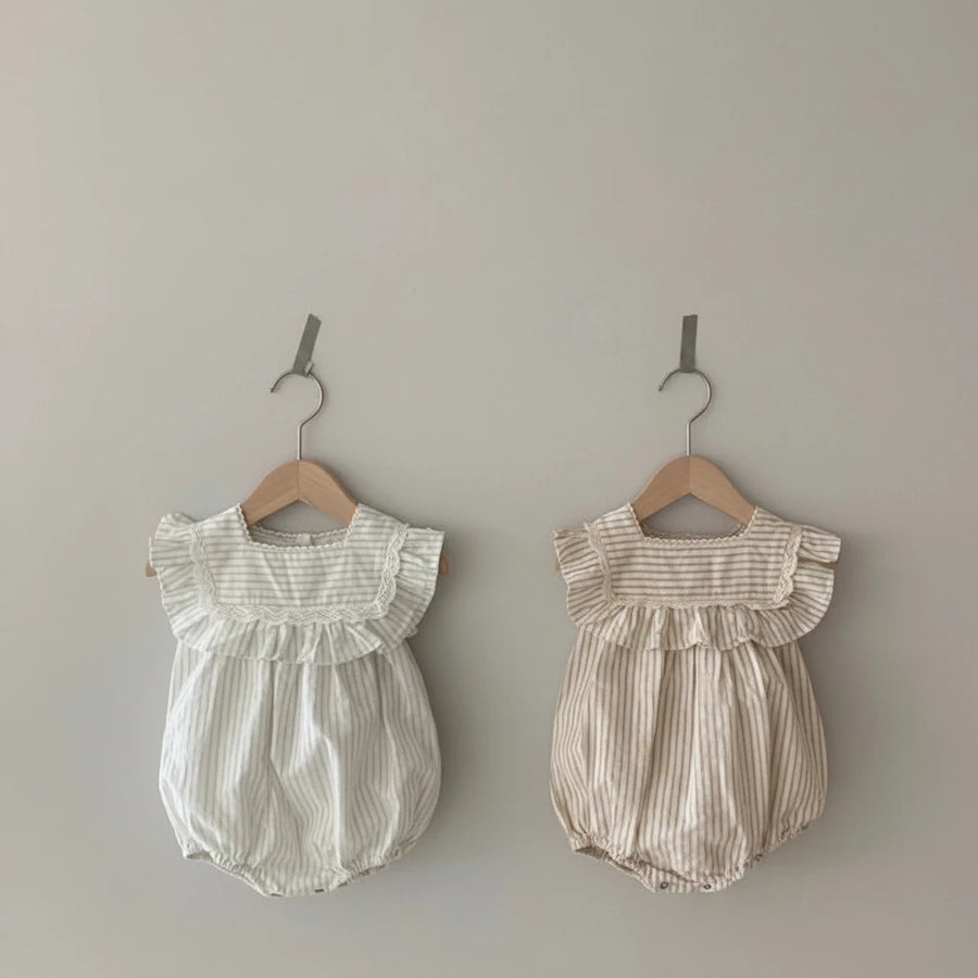Close-up of vintage stripe romper dress with ruffles and lace for girls