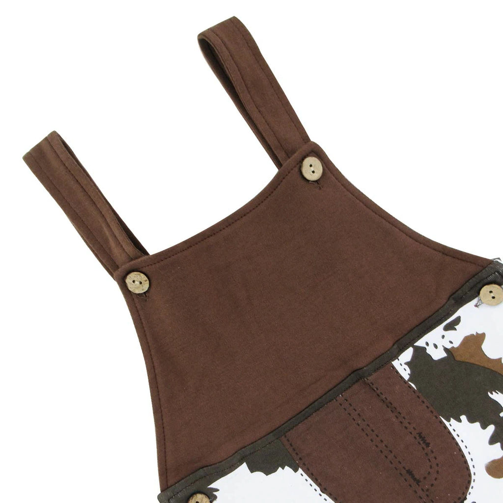 Close-up of brown overall romper shoulder straps and buttons
