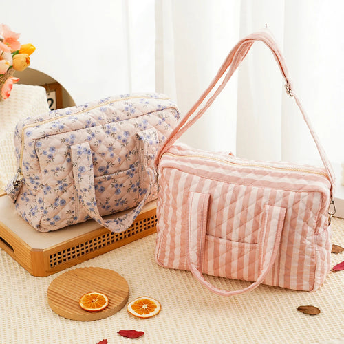 Quilted multi-functional diaper bag with crossbody strap and multiple compartments