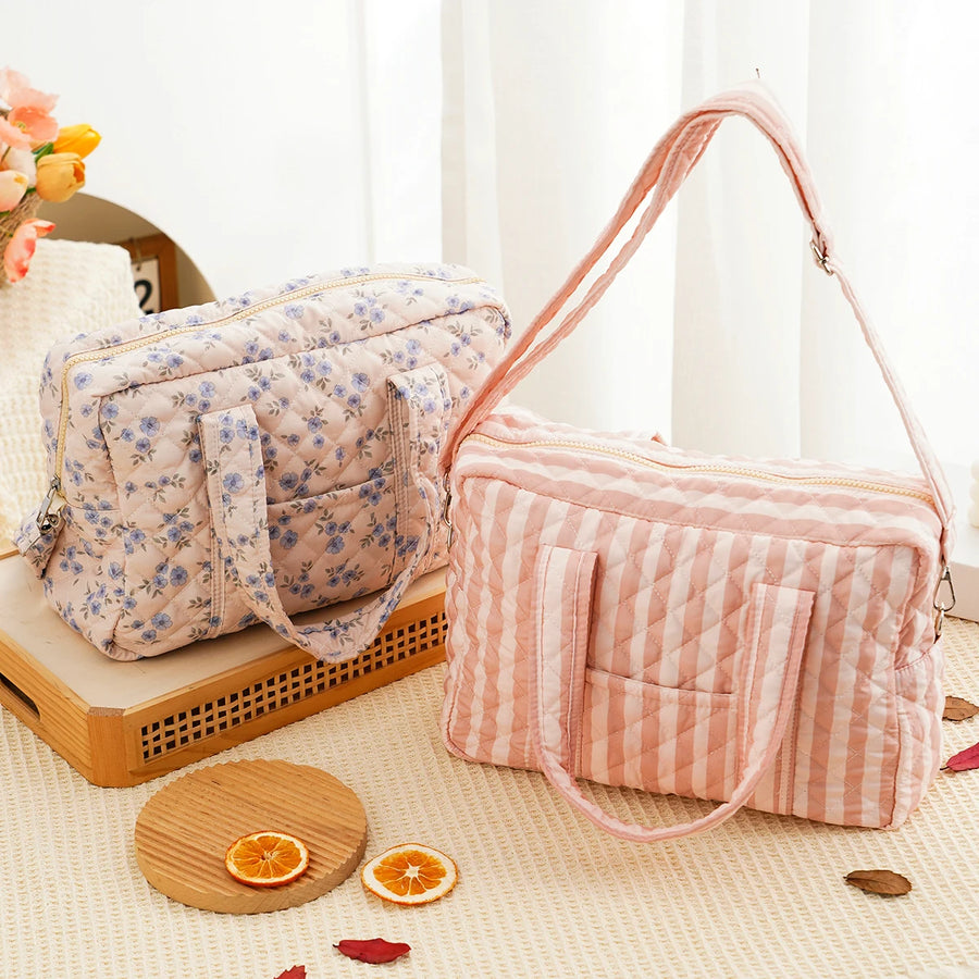 Quilted multi-functional diaper bag with crossbody strap and multiple compartments