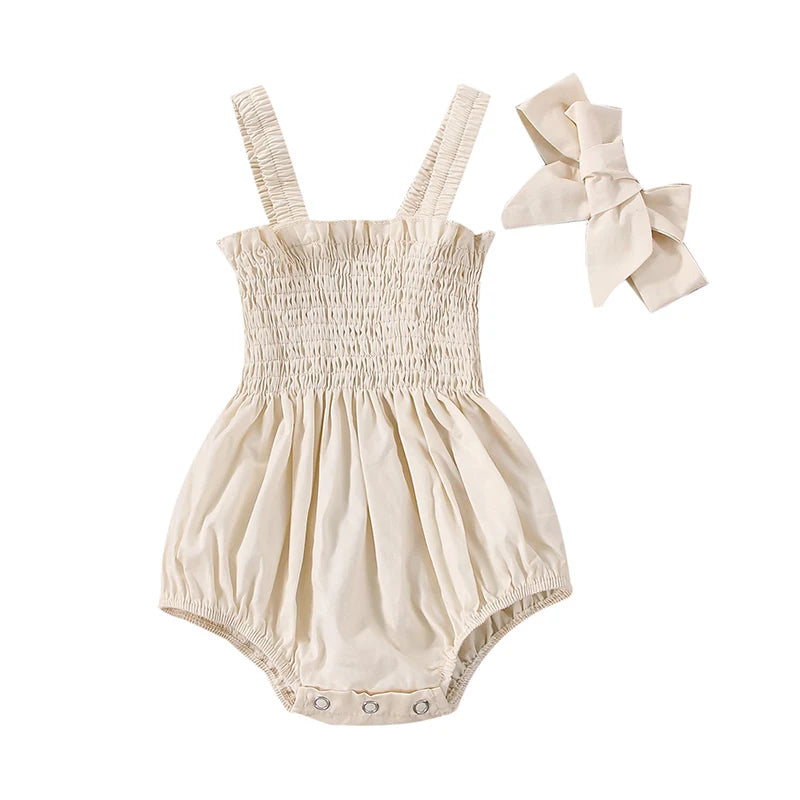 Ruched romper set laid out with matching headband