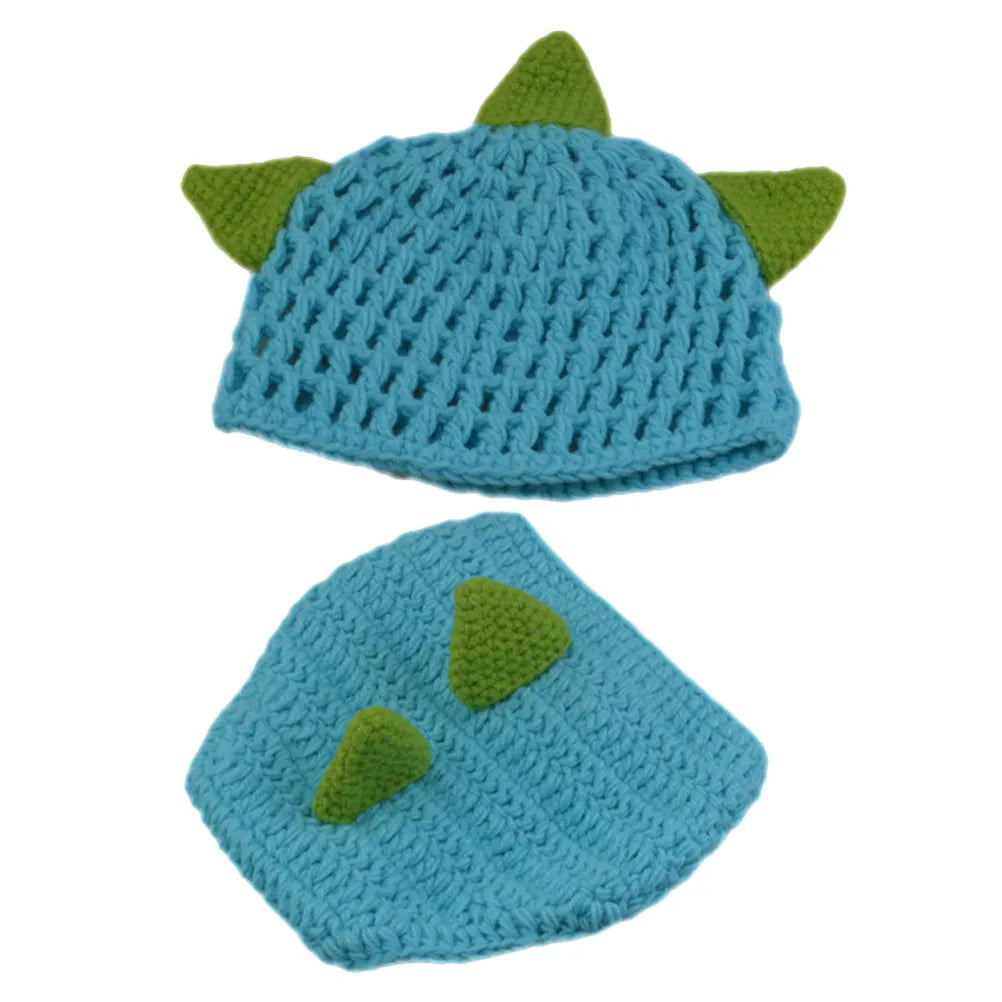 Blue knitted baby hat with green dinosaur spikes and matching diaper cover