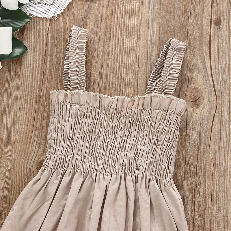 Flat lay of ruched romper and matching headband