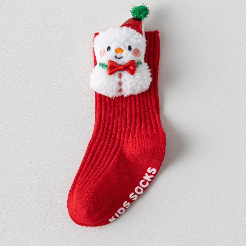 Red ribbed baby sock with a white snowman applique, red bow tie, and pointed red hat with a green pom-pom.