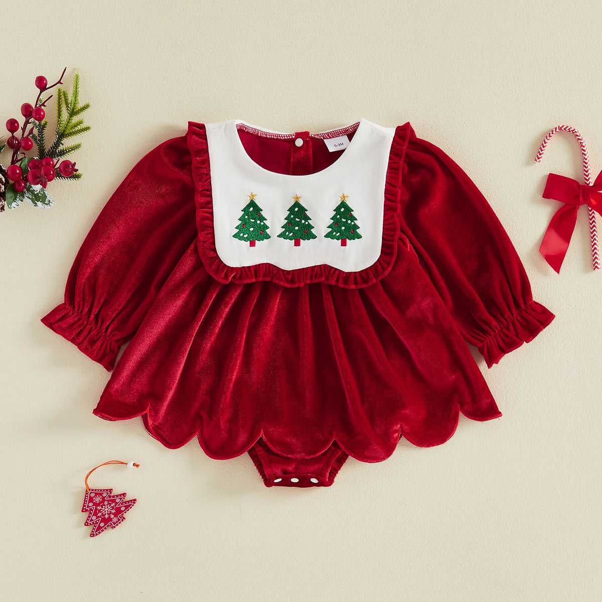 Deep red baby romper dress with long puff sleeves, a scalloped skirt, and three green Christmas trees on a white front panel.