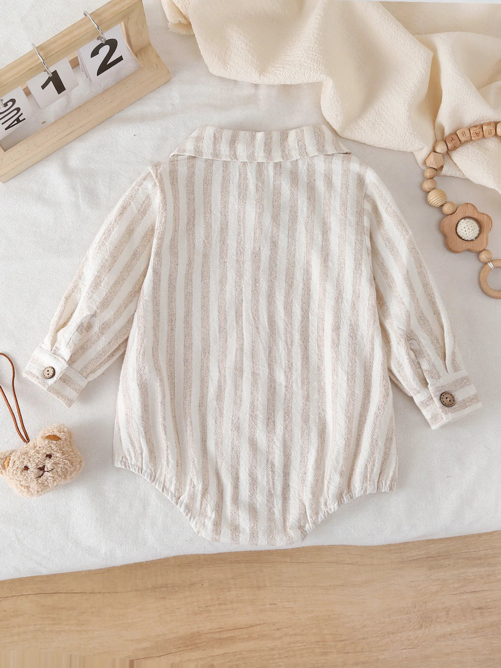 Side view of Striped Long-Sleeve Bodysuit with Crotch Snaps