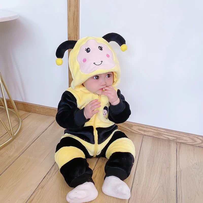 Child wearing yellow bumblebee plush hooded romper costume sitting on floor
