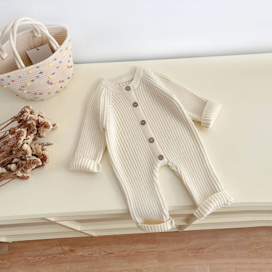 Knitted baby bodysuit in neutral color