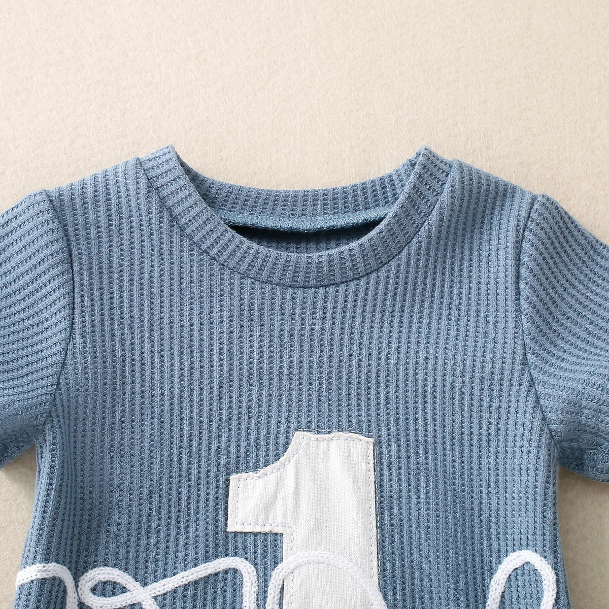 Side view of Embroidered Triangle Romper in Sky Blue