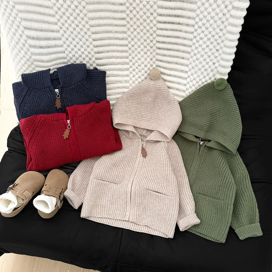 Baby wearing warm knit hooded coat in red color