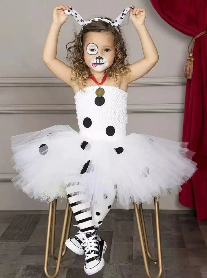 Child wearing white Dalmatian dog tutu dress costume with spotted leggings and dog ear headband
