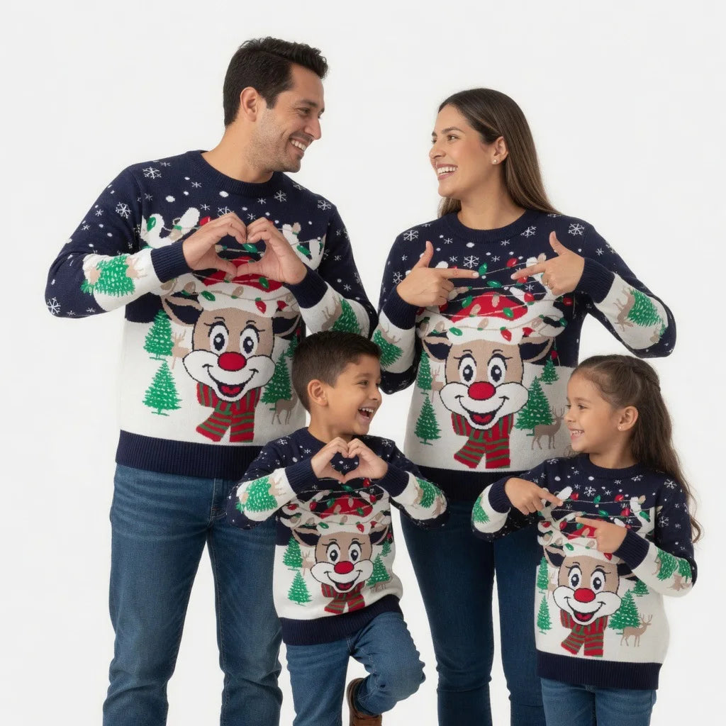 Two adults and two children wearing navy-and-cream sweaters with large smiling reindeer faces, green trees, snowflakes, and Christmas light details.