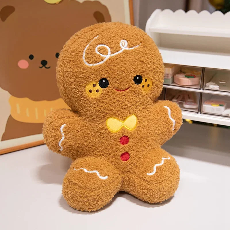Gingerbread Man Christmas plush figure with white icing-style stitching, red details, and a yellow bow