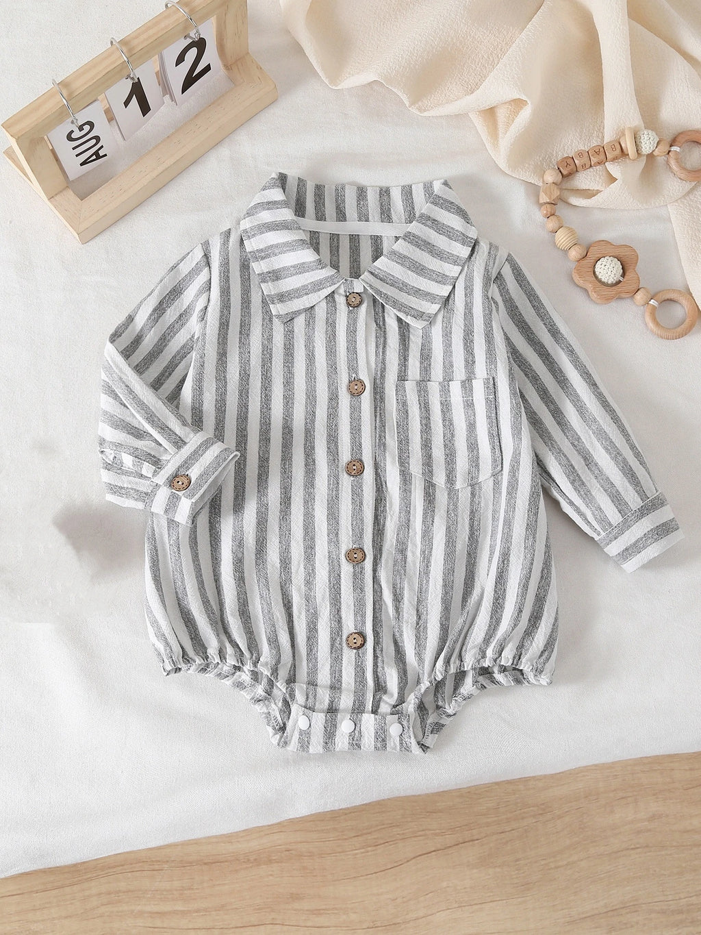 Striped Long-Sleeve Bodysuit laid flat showing full design