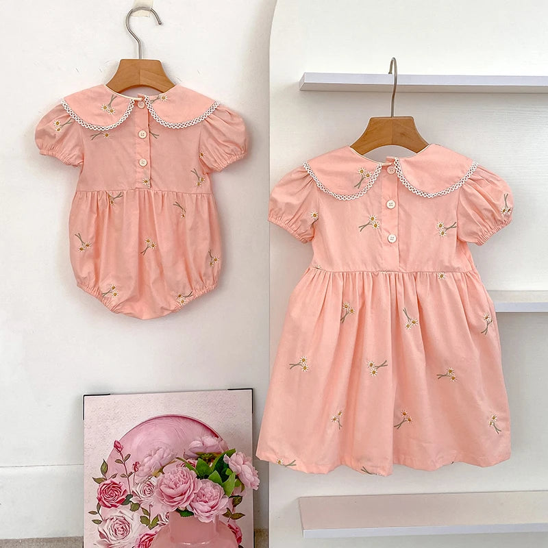 Girls wearing embroidered princess dress and romper set in summer colors
