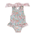 Floral Bow Backless Swimsuit displayed on hanger