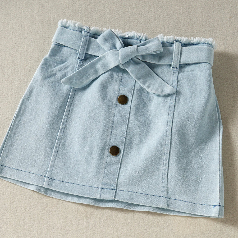 Blue skirt waistband, tie, and button construction detail