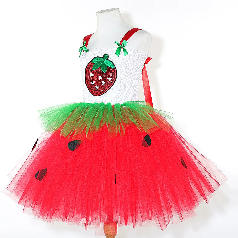 Strawberry tutu dress side view on mannequin showing red straps with green bows and tulle skirt