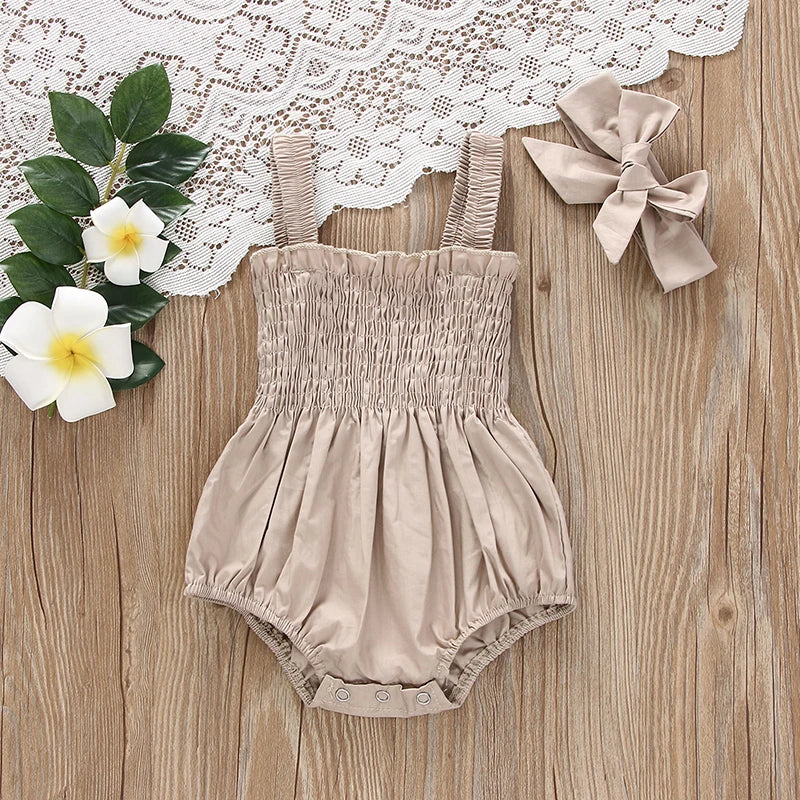 Close-up of ruched detailing on baby girl romper