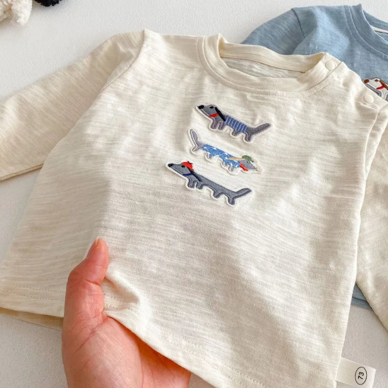 Close view of the beige cotton fabric and embroidery