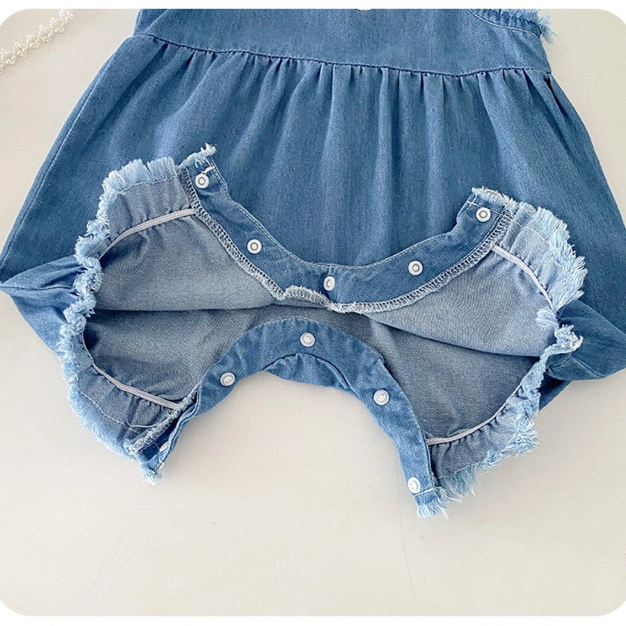 Detail of cotton denim fabric on overall romper