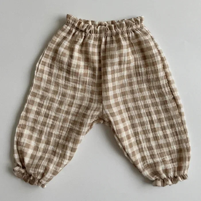 Plaid baby pants on a gray background