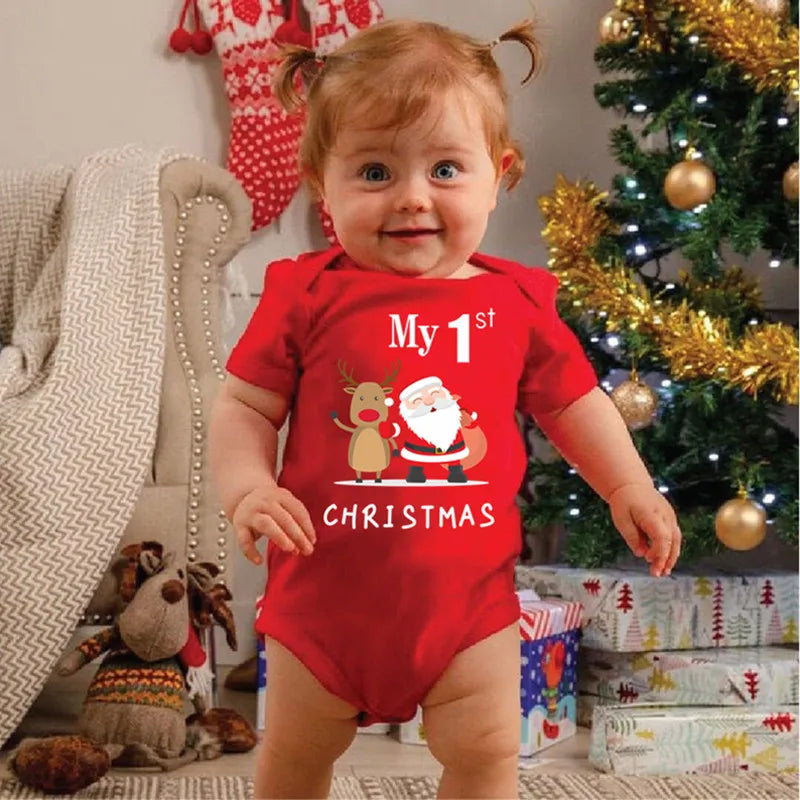 Baby wearing a red short-sleeve My 1st Christmas bodysuit with Santa and reindeer graphics.