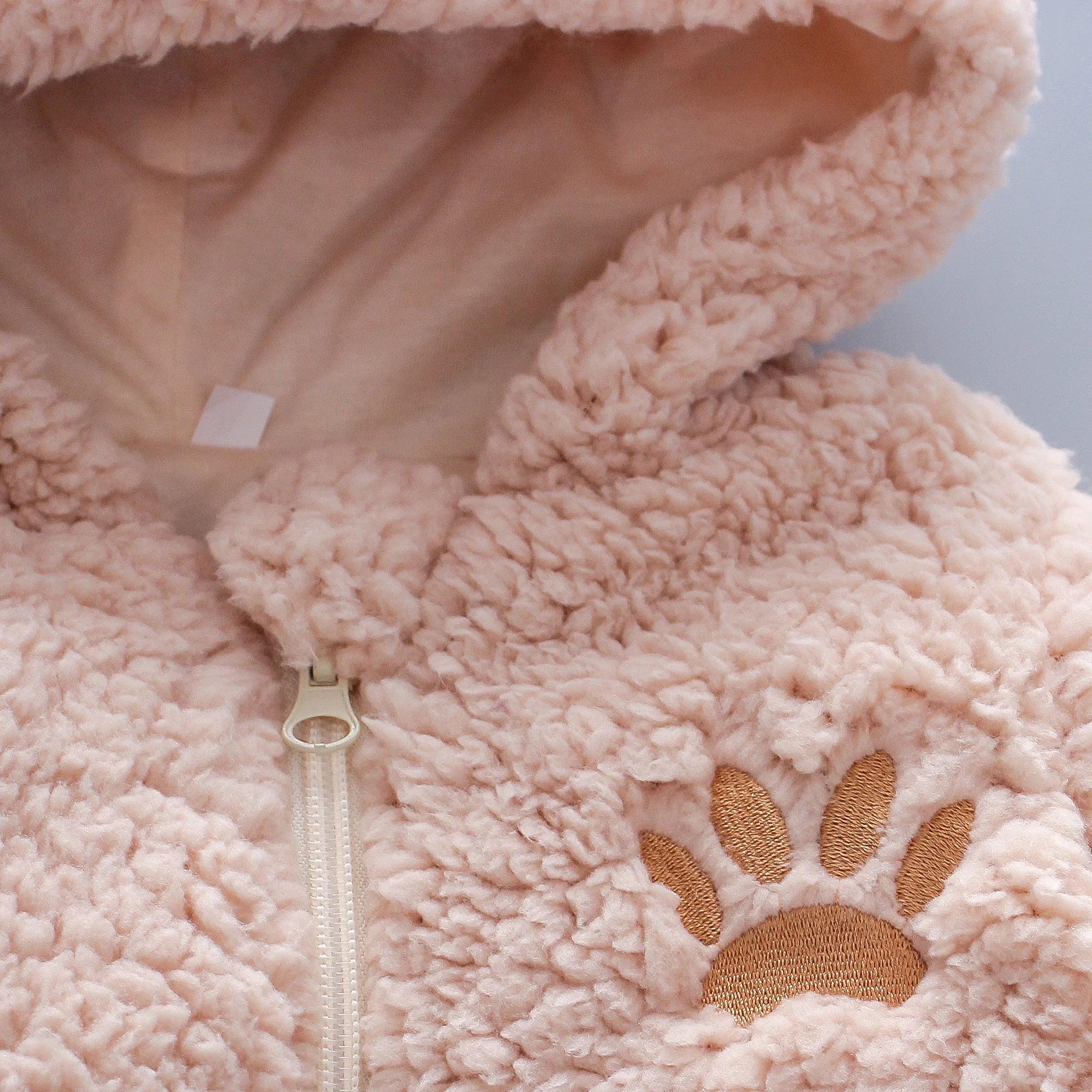 Baby romper with lamb hair fabric and hood, shown in white color