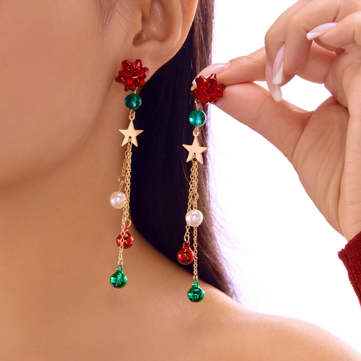 Red gift-bow tops, green bead accents, stars, and long chains with red and green bell-shaped charms.