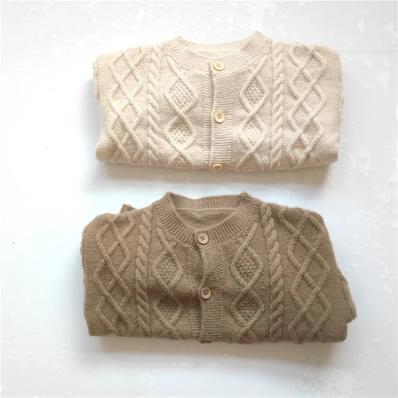 Button closure detail on baby knit cardigan sweater